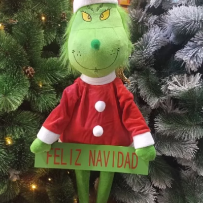 Grinch patilarga con letrero Feliz Navidad